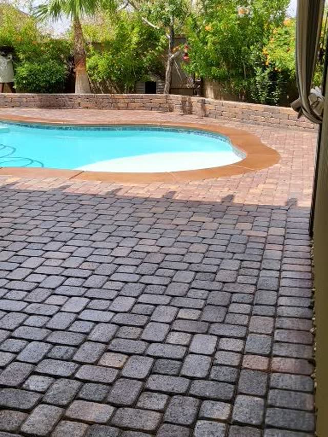 Paver deck around a kidney-shaped pool