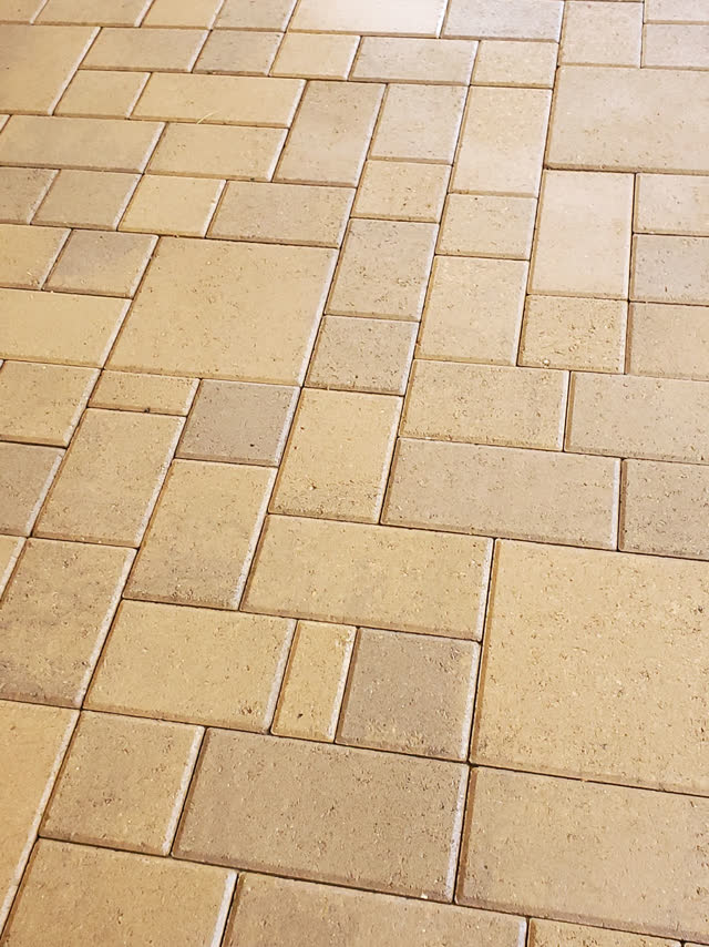 Close-up of sealed tan pavers