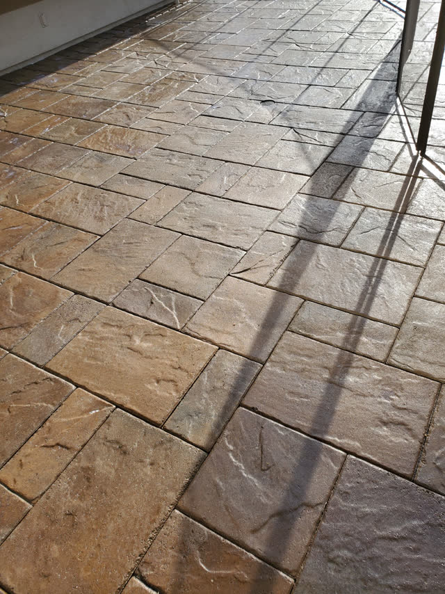 Textured slab pavers under a covered patio
