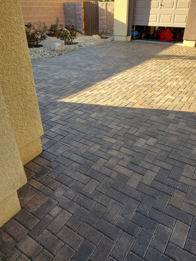 Herringbone paver driveway in charcoal and tan