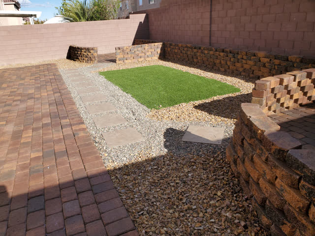 Paver patio with retaining walls and turf