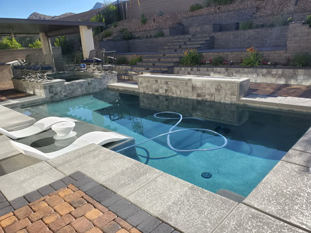 Pool deck with tiered retaining walls