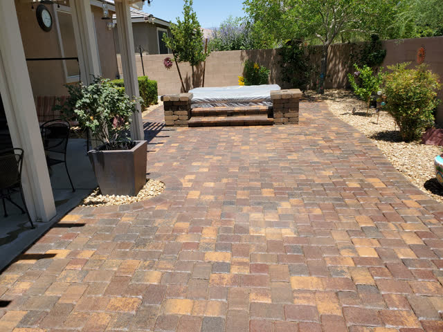Paver patio leading to a spa