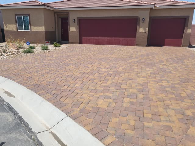 Sealed paver driveway at a three-car garage