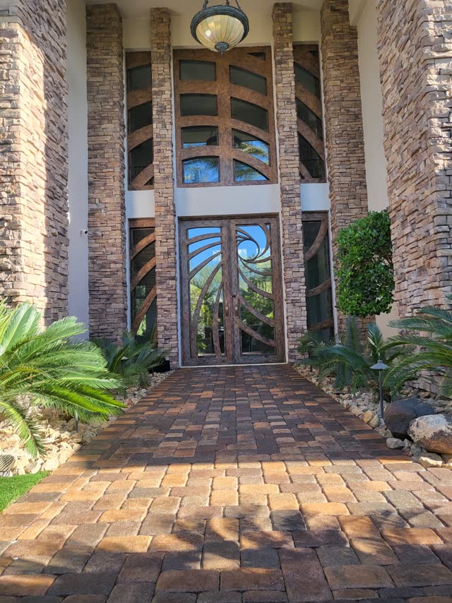 Sealed paver walkway to a grand stone entry