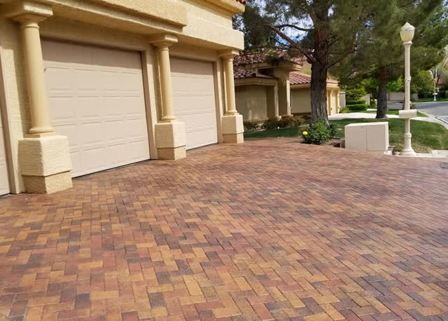 Multi-color paver driveway at a column-front home