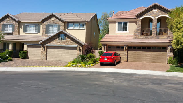 Two neighboring driveways, both sealed