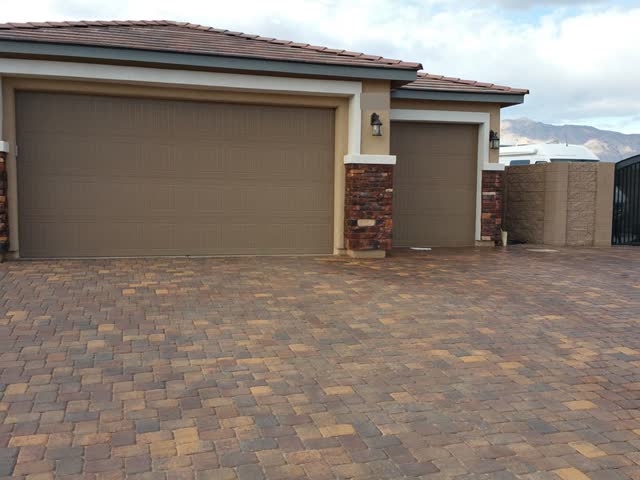 Very large paver driveway and stone columns, sealed