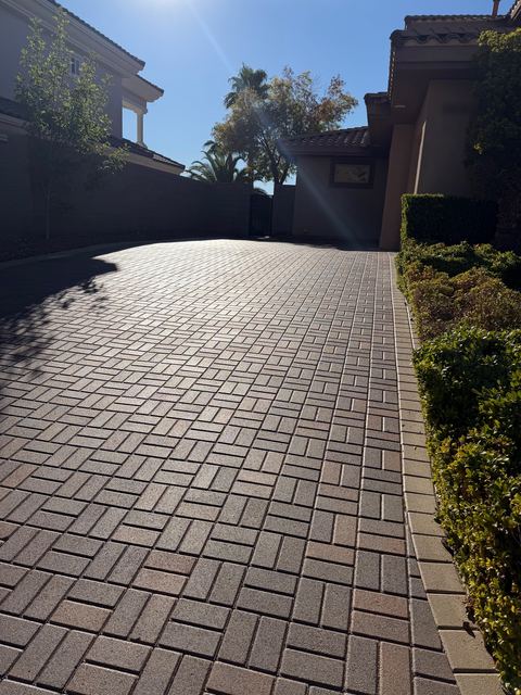 Long sealed paver driveway in afternoon sun