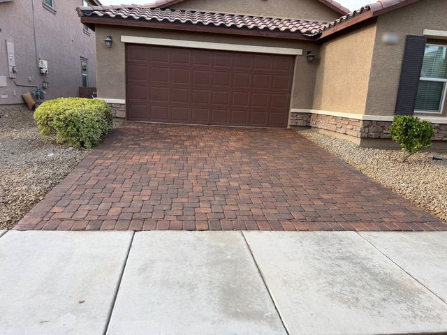 Freshly sealed paver driveway after oil stain removal