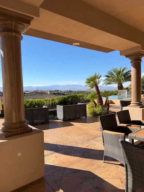 Covered stamped concrete patio with a mountain view