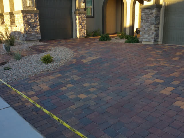 Sealed driveway and entry at a stone-column home