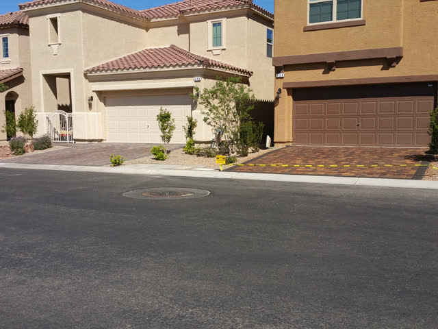 Sealed driveway next to an unsealed neighbor
