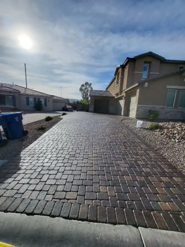 Long paver driveway at a two-story home