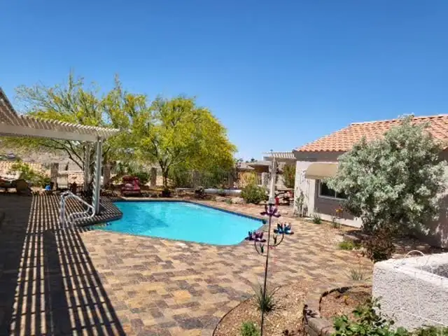 Paver pool deck under a pergola