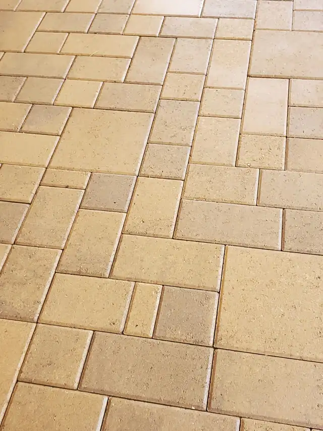 Close-up of sealed tan pavers
