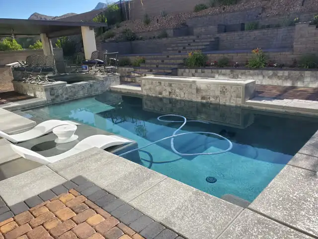 Pool deck with tiered retaining walls