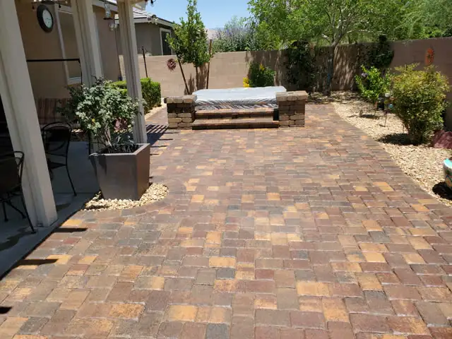 Paver patio leading to a spa