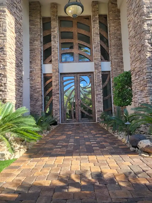 Sealed paver walkway to a grand stone entry