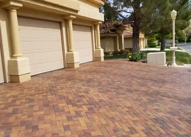Multi-color paver driveway at a column-front home