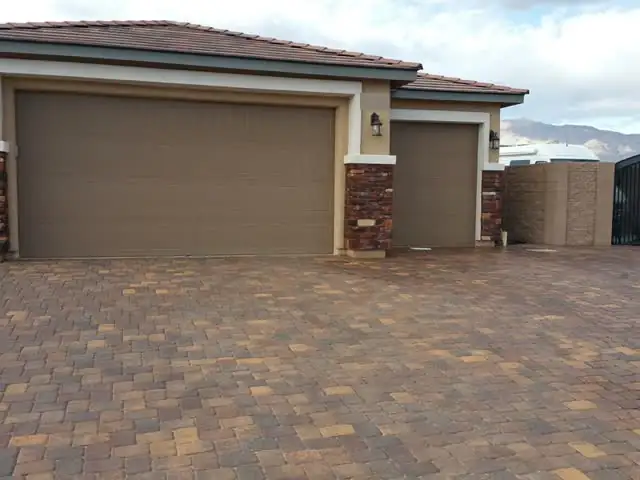 Very large paver driveway and stone columns, sealed
