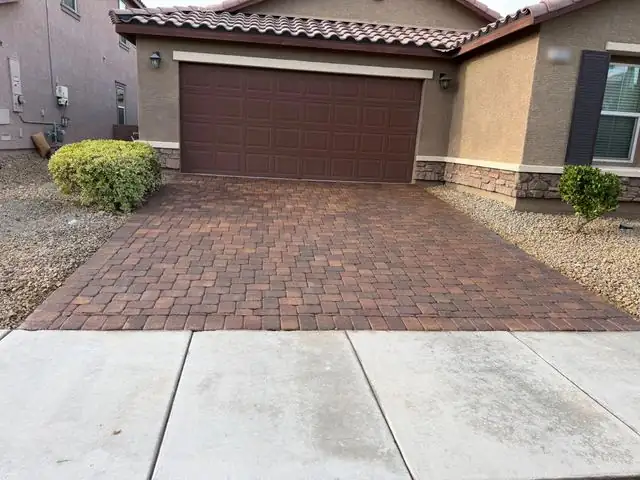 Freshly sealed paver driveway after oil stain removal