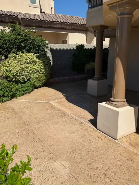 Stamped concrete patio between the columns