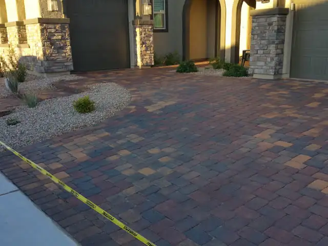 Sealed driveway and entry at a stone-column home